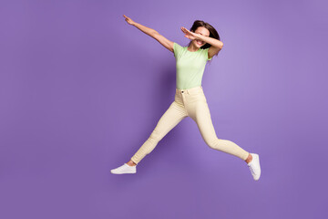Fototapeta na wymiar Full length body size view of her she nice attractive pretty cheerful cheery funky girlish girl jumping having fun dancing showing dab isolated bright vivid shine vibrant lilac violet color background