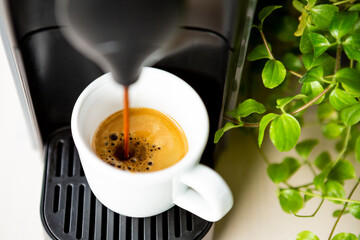 Closeup of espresso coffee in the making in a coffee machine.