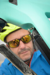 Cyclist places the battery cover on his electric bike