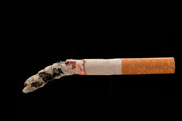 Cigarette burning tobacco with ash isolated on black background
