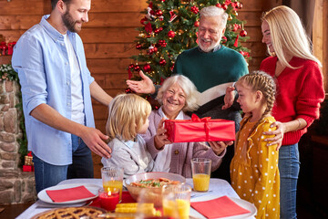 mature woman get presents by extended family, children and husband please her with gifts, she is happy