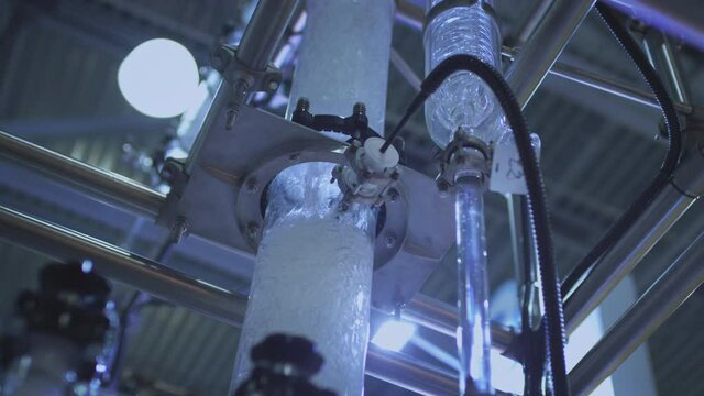 Water pump and pipes. Transparent pipe to show water flows inside the water supply system.