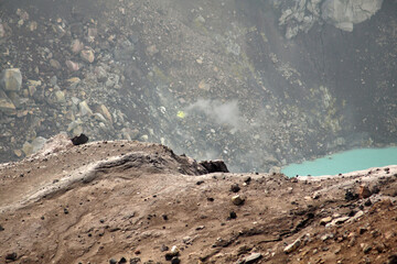 Kamchatka. Gorely Volcano (Burnt Volcano). Turquoise lake in the crater of a volcano. Smoke fumaroles on the slopes of the crater. Archive photo, 2008