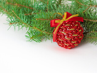 Christmas ball and fir branch on white background