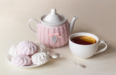 Teapot, cup of tea and marshmallows