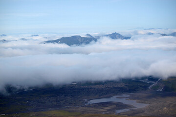 Kamchatka. Gorely Volcano (Burnt Volcano). Mountain peaks rising above the fog. Archive photo, 2008