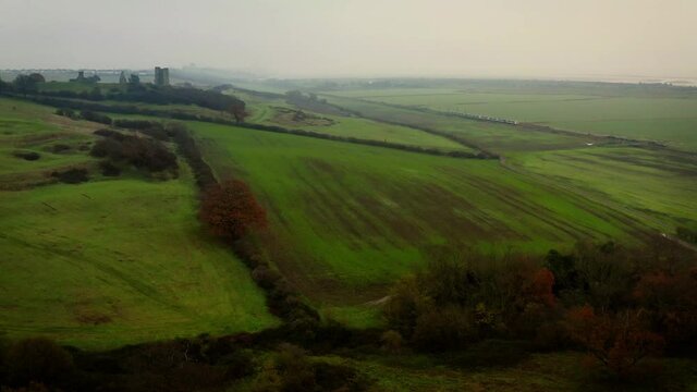 Aerial Hadleigh Castle on left as drone lifts to show train travelling DJI Mavic 2 Pro 4K