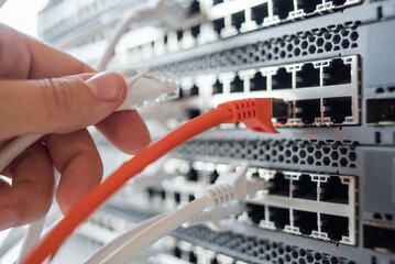 Working switches in data center with white and red cables