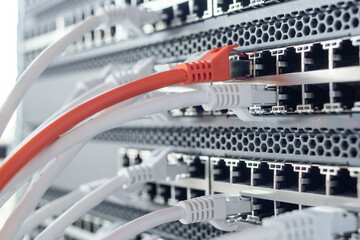 Working switches in data center with white and red cables