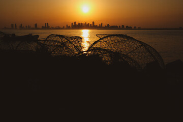 silhouette of the fishing boat and fisher man in Nurana island Bahrain