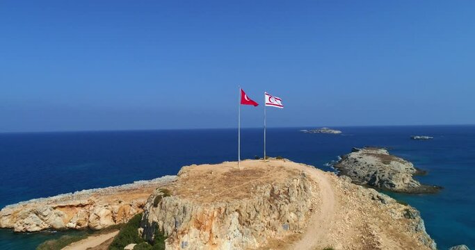 Northern Cyprus, two big flags flying on the Cape of Victory. Northern Cyprus and Turkey flags. 4K. aerial view.