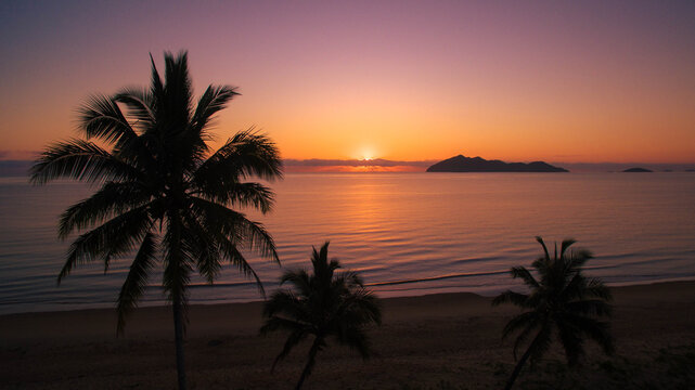 Beautiful Sunset in Australia Palm foreground dunk island in background on mission beach