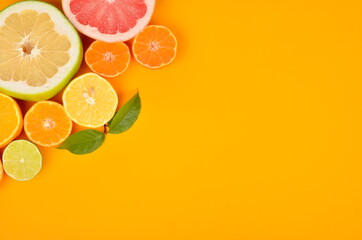 Corners placed and sliced cut citrus on a yellow background, Citrus background, copy space