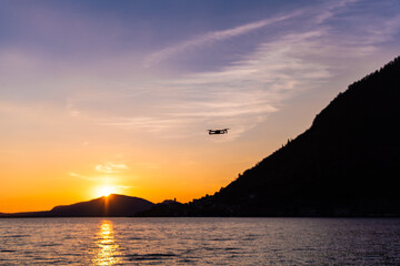 Drone flying above Iseo Lake at sunset