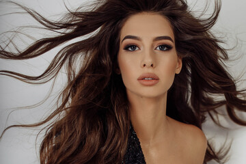 Naklejka premium Close-up photo portrait young woman with hair blowing in air beautiful make-up isolated white color background