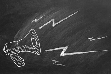 Megaphone hand drawn in chalk on a blackboard
