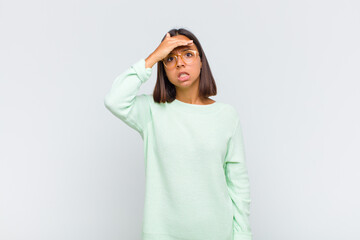 latin woman panicking over a forgotten deadline, feeling stressed, having to cover up a mess or...