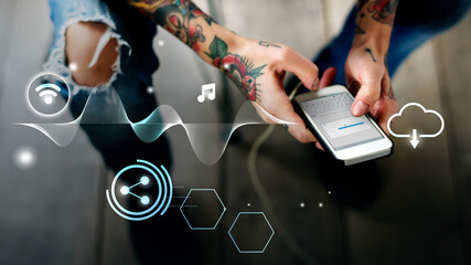 Tattooed woman downloading a file on her phone