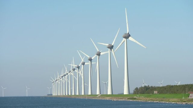 Raw of wind turbines along the shore near village of Urk in Flevoland, The Netherlands