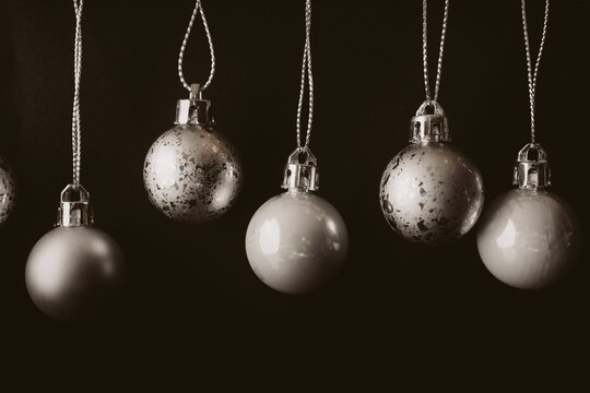 Collection of silver christmas balls on black background with copy space.

