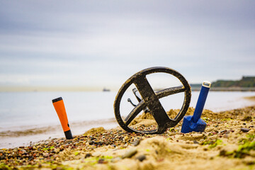 Metal detector with accessories on beach