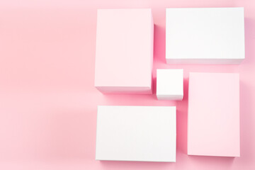 Pink and white geometrical podiums on pink background, horizontal, copy space, top view