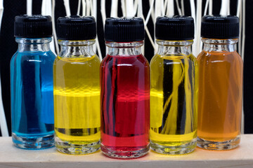 Bottles with perfume on table against blurred background