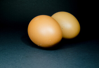 Photo of brown eggs on a dark background. Food in the kitchen