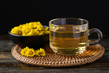 Organic Chrysanthemum flower tea in a cup on black background, Healthy Herbal drink