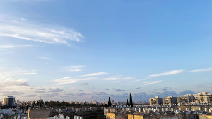 The roofs of city buildings against the background of the sunset