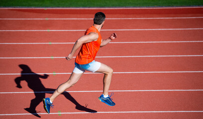 Obraz premium Every day filled with sport. endurance and stamina. runner on racetrack. challenge and competition. marathon speed. sport athlete run fast to win. successful fitness sprinter. coach on running track