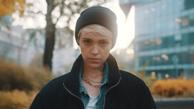 Portrait of blond woman with winter hat and jacket looking angy at the camera. High quality 4k footage
