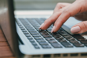 woman using laptop, searching the internet, viewing information, having a job at home