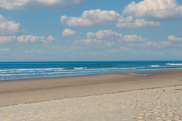 small waves on the beach, blue sky