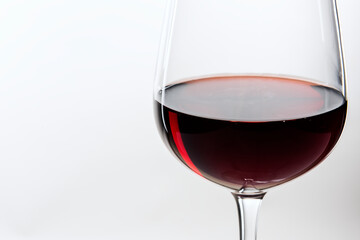 Red wine in a glass on white background