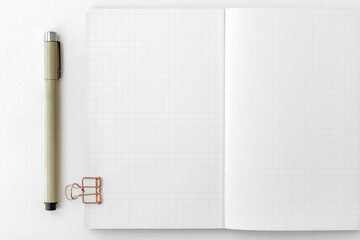 Blank grid patterned notebook page with stationary