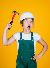 Smart professional. future engineer. happy kid use hammer repairing tool. building construction site. child architect worker. labor day concept. childhood development. teenager girl assistant