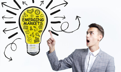 Business, Technology, Internet and network concept. Young businessman working on a virtual screen of the future and sees the inscription: Emerging markets