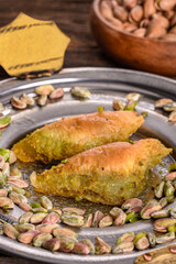 World famous baklava making in Gaziantep. Baklava presentation on wooden board. The Turkish name of this dessert variety is şöbiyet