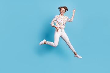 Fototapeta premium Full body photo of young girl happy smile crazy excited jump show like play guitar isolated over blue color background