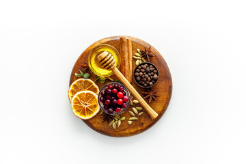 Various spices for preparing mulled wine hot drink. Cinnamon, honey, spices and cranberries