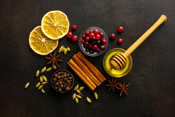 Various spices for preparing mulled wine hot drink. Cinnamon, honey, spices and cranberries