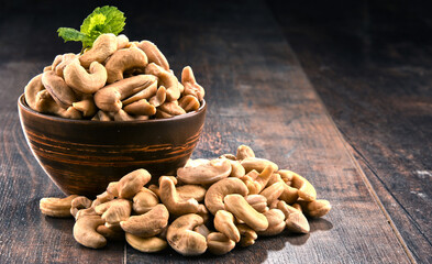 Bowl with cashew nuts on wooden table