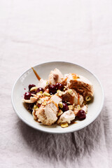 Not traditional Eton mess. Meringue, pistachio, cherry and caramel sauce dessert. Selective focus