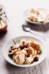 Not traditional Eton mess. Meringue, pistachio, cherry and caramel sauce dessert. Selective focus