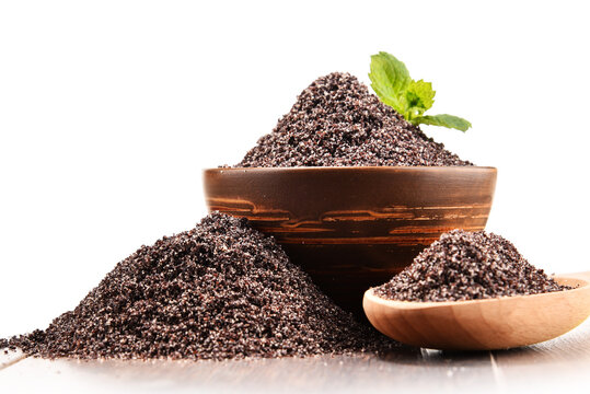 Bowl of poppy seeds on white background