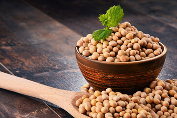 Composition with bowl of soya beans on wooden table
