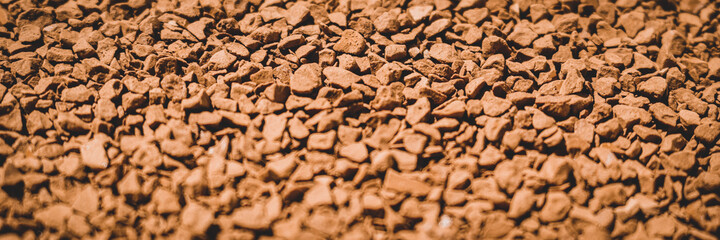 Granules of instant aromatic brown coffee. Web banner.