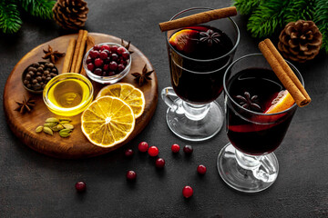 Two cups of mulled wine, spices and dry citrus fruits warming christmas drink