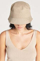 Woman wearing a beige bucket hat mockup